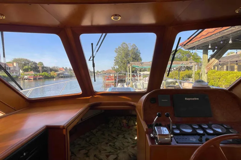 Free Ride Yacht Photos Pics 2002 President Trawler helm view with scenic waterfront and navigational equipment.