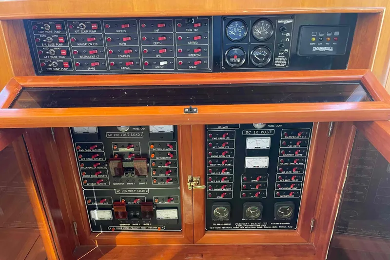 Free Ride Yacht Photos Pics Electrical control panel on a 2002 President Trawler boat, featuring various switches and gauges.