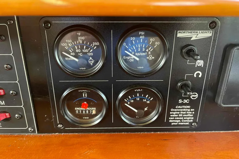 Free Ride Yacht Photos Pics 2002 President Trawler engine panel with gauges for water temperature, oil pressure, and engine hours.