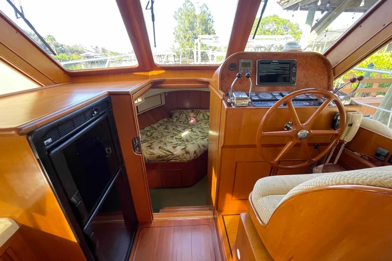 Free Ride Yacht Photos Pics 2002 President Trawler interior with helm, cozy cabin, and wooden finishes.