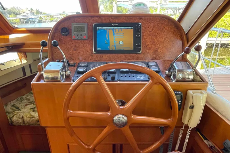 Free Ride Yacht Photos Pics Helm of 2002 President Trawler with navigation equipment and wooden steering wheel.
