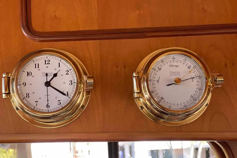 Free Ride Yacht Photos Pics Brass clock and barometer on 2002 President Trawler's wooden interior.