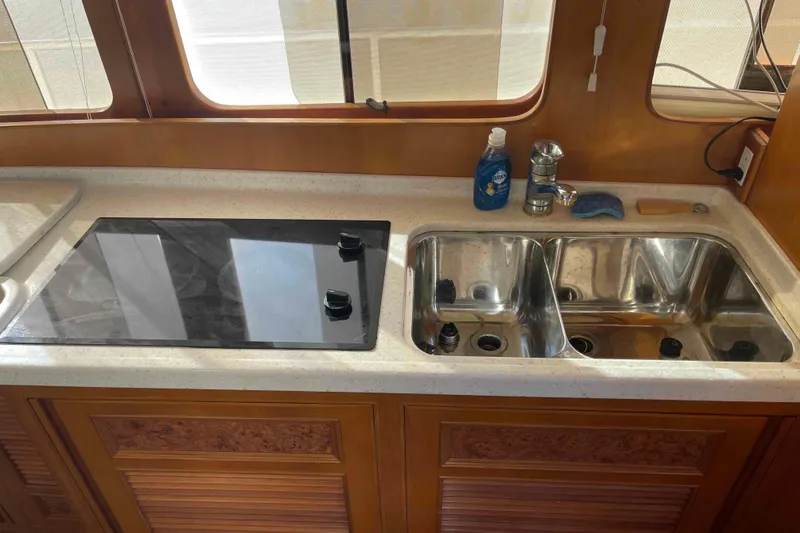 Free Ride Yacht Photos Pics Kitchen area of a 2002 President Trawler with stove and double sink.