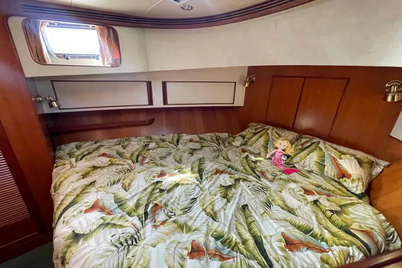 Free Ride Yacht Photos Pics Cozy bedroom in 2002 President Trawler with tropical bedding and a doll.