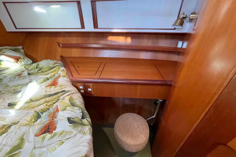 Free Ride Yacht Photos Pics Cozy cabin interior of 2002 President Trawler with wooden desk and tropical bedding.
