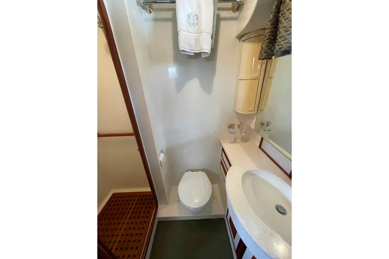 Free Ride Yacht Photos Pics Compact bathroom in 2002 President Trawler with sink, toilet, and shower area.