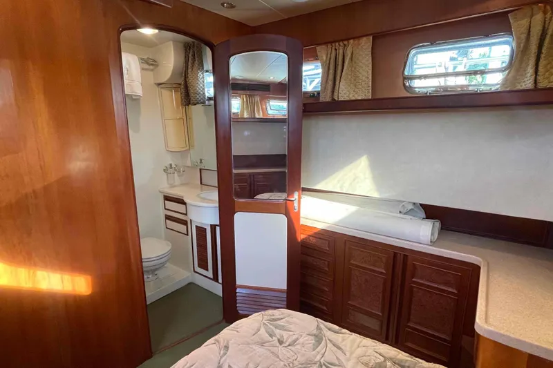 Free Ride Yacht Photos Pics Luxurious 2002 President Trawler cabin interior with wood finish and ensuite bathroom.