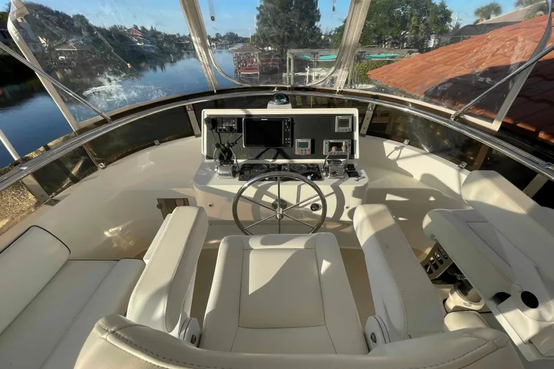 Free Ride Yacht Photos Pics Helm of 2002 President Trawler with modern controls and scenic waterway view.