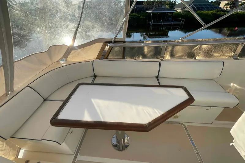 Free Ride Yacht Photos Pics 2002 President Trawler interior with white cushioned seating and table, overlooking serene water view.