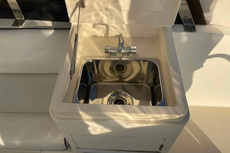Free Ride Yacht Photos Pics Stainless steel sink on 2002 President Trawler yacht, reflecting sunlight.