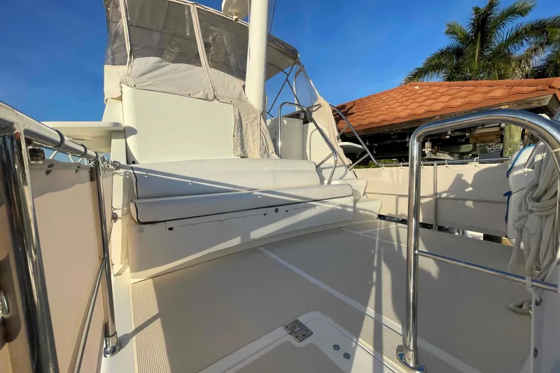 Free Ride Yacht Photos Pics 2002 President Trawler deck with seating, stainless steel railings, and clear blue sky.