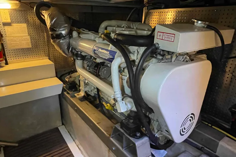 Free Ride Yacht Photos Pics Engine room of a 2002 President Trawler with detailed machinery and components.