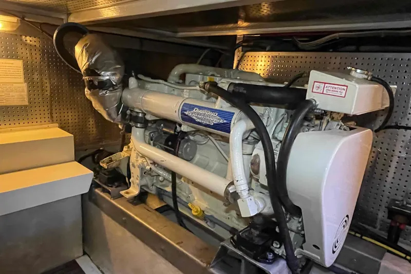 Free Ride Yacht Photos Pics Engine room of a 2002 President Trawler, featuring a diesel engine and mechanical components.