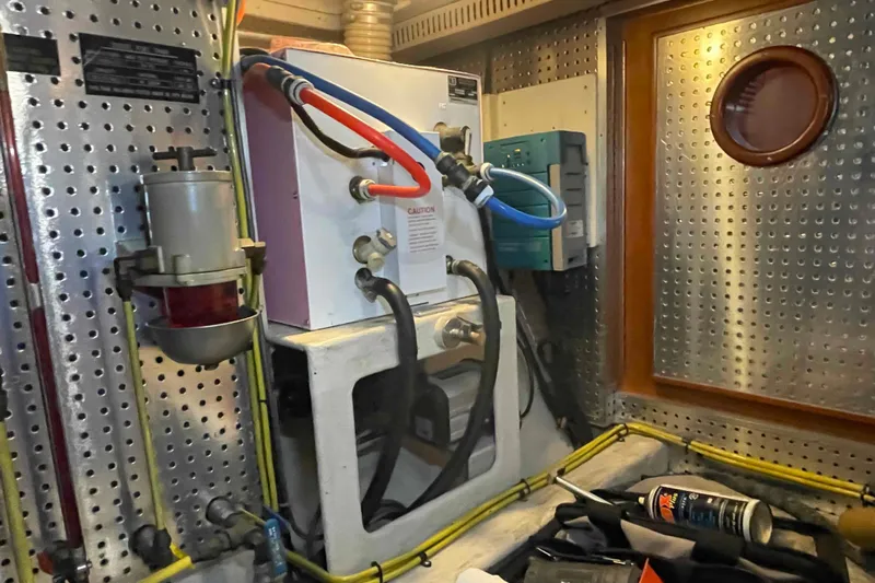 Free Ride Yacht Photos Pics Engine room of a 2002 President Trawler with mechanical components and wiring.