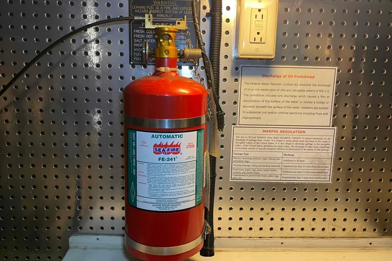 Free Ride Yacht Photos Pics Automatic fire extinguisher on 2002 President Trawler, with safety and regulation notices.