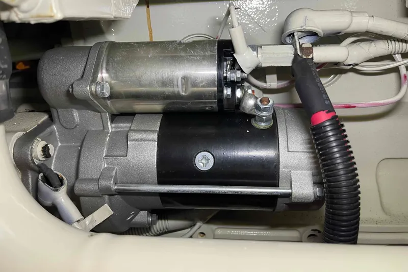 Free Ride Yacht Photos Pics Engine component of a 2002 President Trawler, featuring wiring and metallic parts.