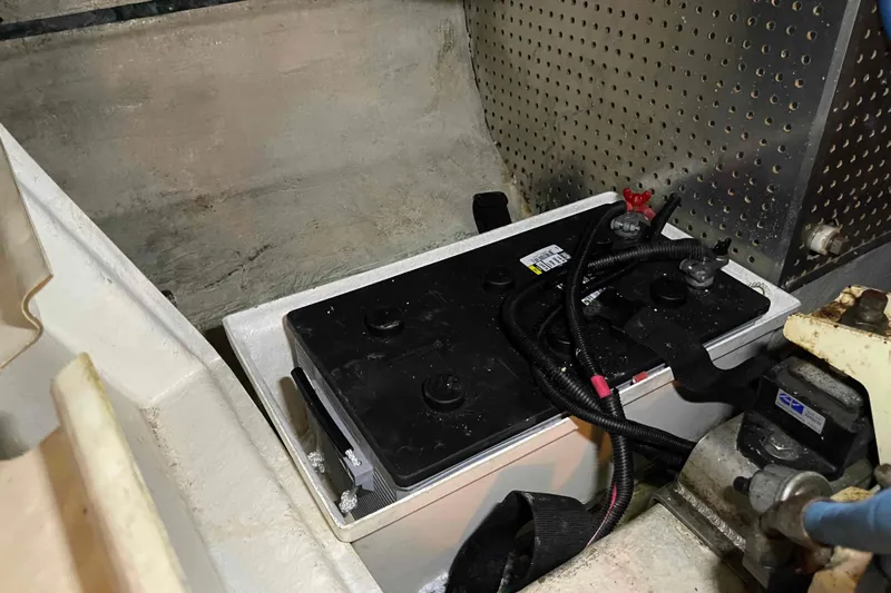Free Ride Yacht Photos Pics Battery compartment in a 2002 President Trawler boat, featuring wiring and secure installation.