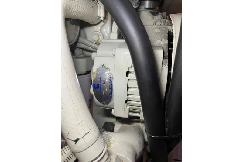 Free Ride Yacht Photos Pics Engine component of a 2002 President Trawler with visible Cummins label and hoses.