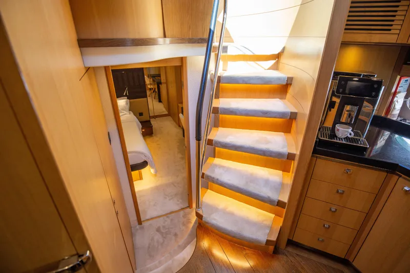  Yacht Photos Pics Luxurious interior of 2012 Princess V72 yacht with elegant staircase and modern amenities.