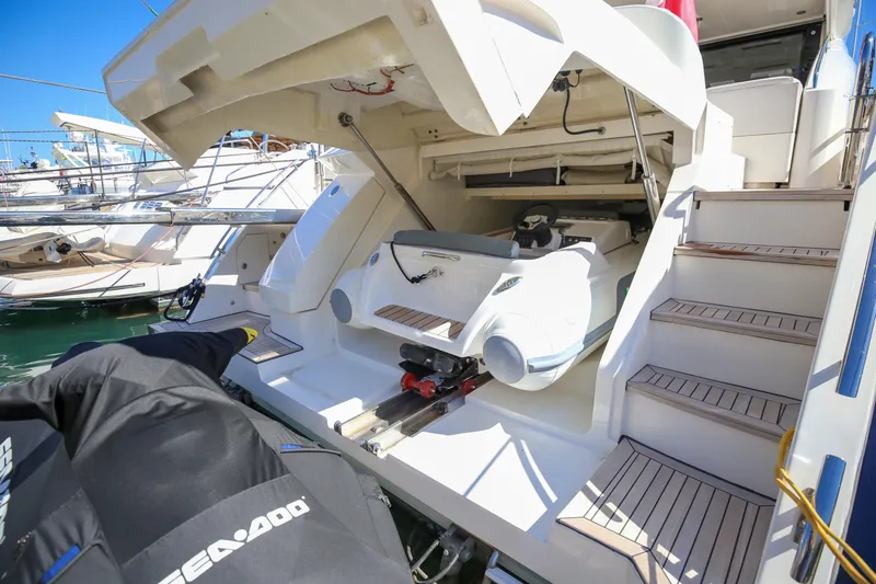  Yacht Photos Pics 2012 Princess V72 yacht with a hidden jet ski compartment, docked at a marina.