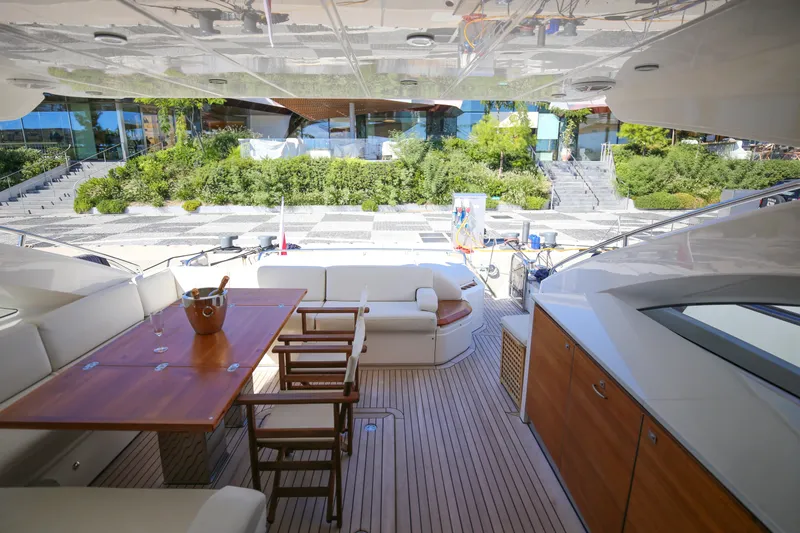  Yacht Photos Pics Luxurious 2012 Princess V72 yacht deck with elegant seating and wooden table.