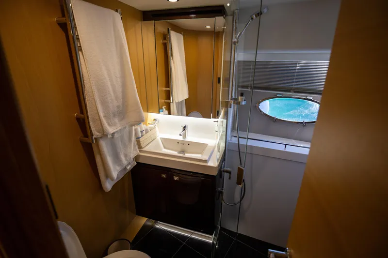 Yacht Photos Pics Luxurious bathroom in 2012 Princess V72 yacht with modern fixtures and porthole window.