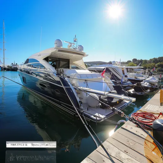  Yacht Photos Pics Luxurious 2013 Princess V72 yacht docked in a sunny marina.