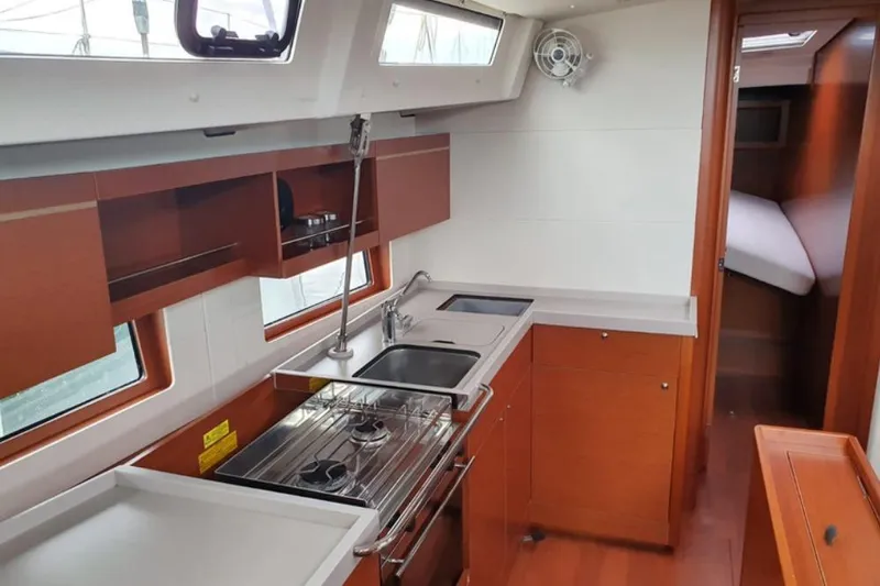  Yacht Photos Pics Interior of 2019 Beneteau Oceanis 46.1 yacht, featuring modern kitchen and cozy cabin.