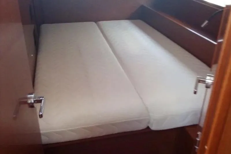  Yacht Photos Pics Interior cabin of 2019 Beneteau Oceanis 46.1 yacht with comfortable bedding.
