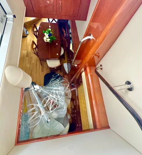  Yacht Photos Pics Interior view of 2006 Marquis 65 yacht, featuring elegant dining area and wooden finishes.