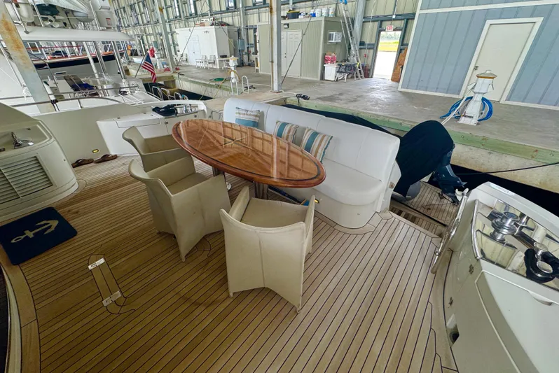  Yacht Photos Pics Luxury yacht Marquis 65, 2006 model, featuring elegant outdoor seating and dining area.