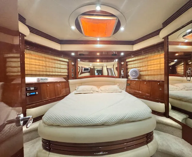 Yacht Photos Pics Luxurious 2006 Marquis 65 yacht bedroom with elegant wood finishes and ambient lighting.