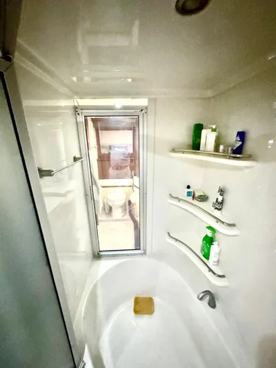  Yacht Photos Pics Luxurious bathroom in 2006 Marquis 65 yacht with modern fixtures and ample storage.