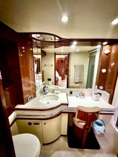  Yacht Photos Pics Luxurious bathroom in a 2006 Marquis 65 yacht with elegant wood accents.