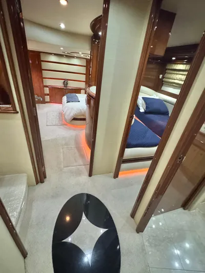  Yacht Photos Pics Luxurious interior of a 2006 Marquis 65 yacht with elegant bedrooms and ambient lighting.