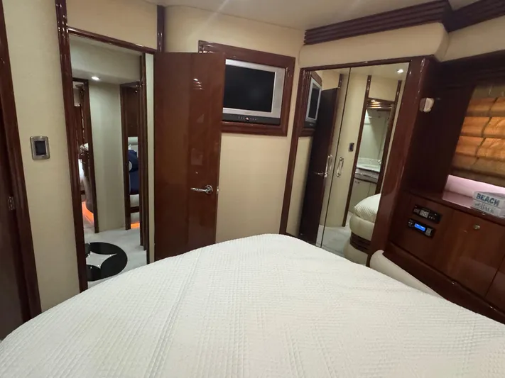  Yacht Photos Pics Luxurious interior of a 2006 Marquis 65 yacht bedroom with modern amenities.