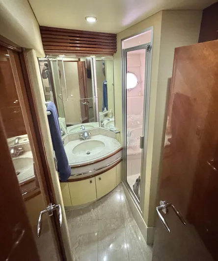  Yacht Photos Pics Luxurious bathroom in a 2006 Marquis 65 yacht with modern fixtures and elegant design.
