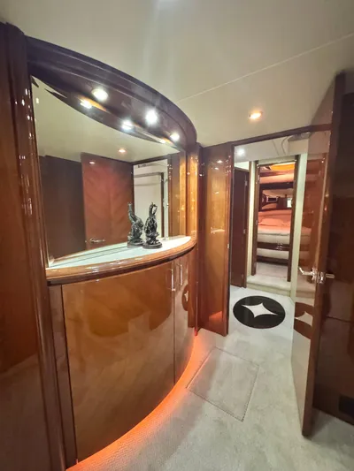  Yacht Photos Pics Luxurious interior of a 2006 Marquis 65 yacht with elegant wood finishes and ambient lighting.
