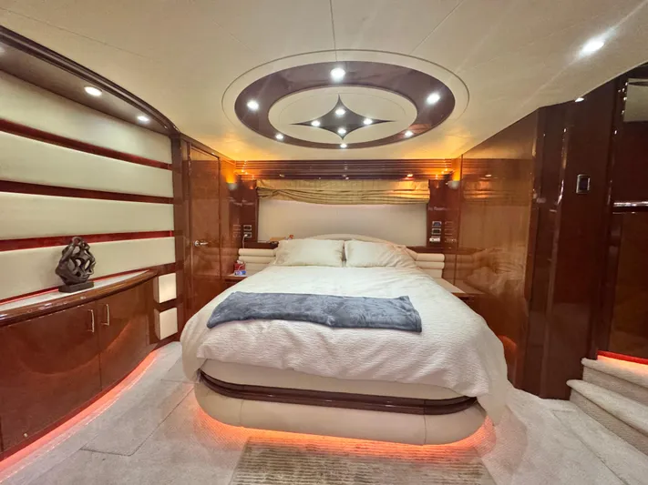  Yacht Photos Pics Luxurious bedroom interior of a 2006 Marquis 65 yacht with modern lighting and elegant decor.