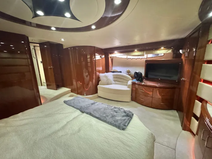  Yacht Photos Pics Luxurious interior of a 2006 Marquis 65 yacht with elegant wood finishes and cozy seating.