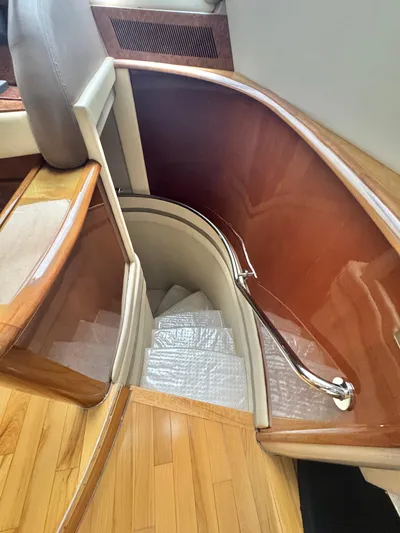  Yacht Photos Pics Curved wooden staircase in a 2006 Marquis 65 yacht interior.