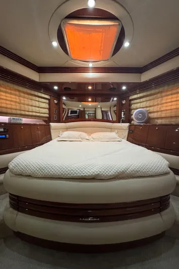  Yacht Photos Pics Luxurious 2006 Marquis 65 yacht bedroom with elegant wood finishes and ambient lighting.
