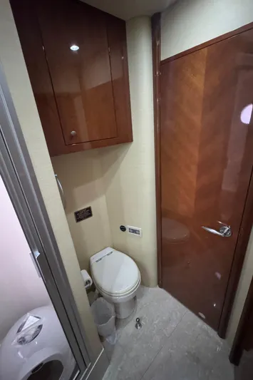  Yacht Photos Pics Luxury yacht bathroom interior, Marquis 65, 2006 model, featuring wooden cabinetry and modern fixtures.