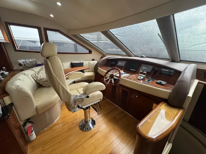  Yacht Photos Pics Luxurious 2006 Marquis 65 yacht interior with elegant helm and seating area.
