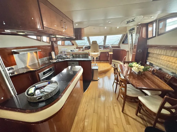  Yacht Photos Pics Luxurious interior of a 2006 Marquis 65 yacht with elegant wood finishes.