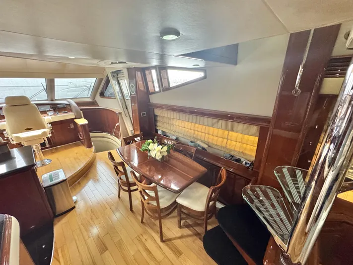  Yacht Photos Pics Luxurious interior of a 2006 Marquis 65 yacht with elegant dining area and helm.
