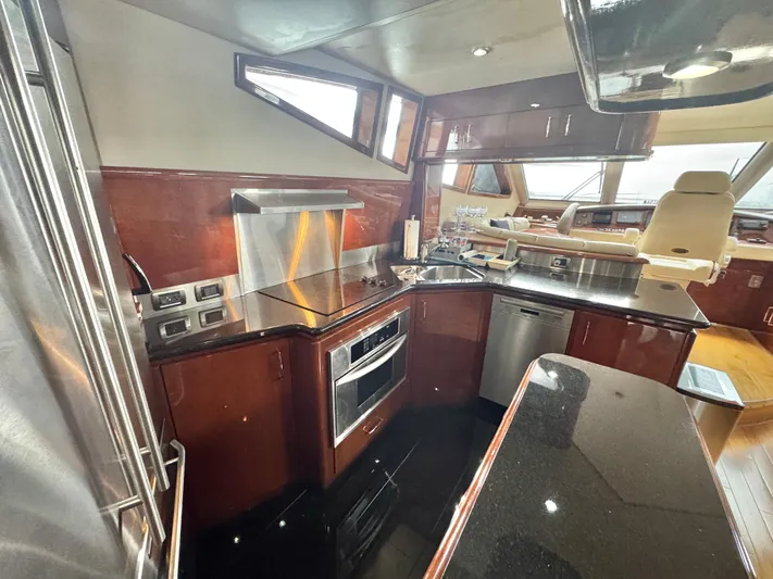  Yacht Photos Pics Luxurious kitchen interior of a 2006 Marquis 65 yacht with modern appliances and sleek design.