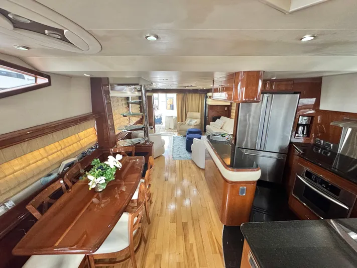  Yacht Photos Pics Luxurious interior of a 2006 Marquis 65 yacht with elegant dining and kitchen area.