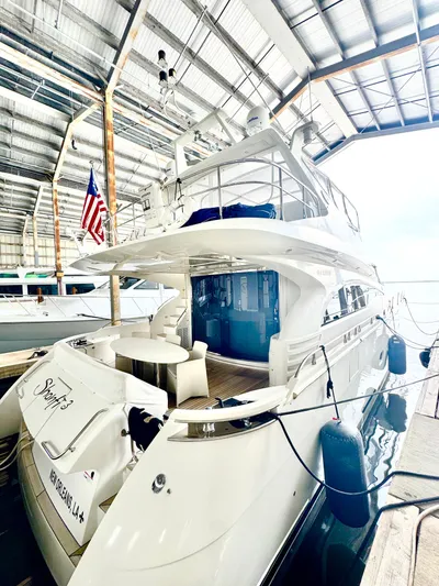  Yacht Photos Pics Luxury 2006 Marquis 65 yacht docked in a covered marina.