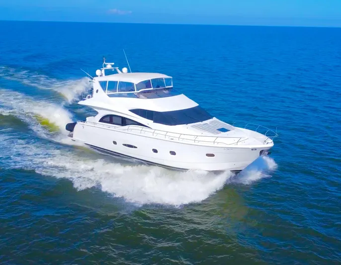  Yacht Photos Pics Luxury 2006 Marquis 65 yacht cruising on open blue sea.